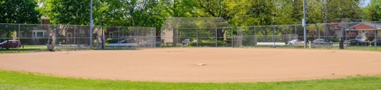 Wide shot of little league field looking at home plate from center field.