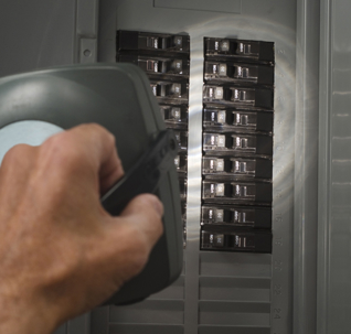 Man with flashlight at residential service panel